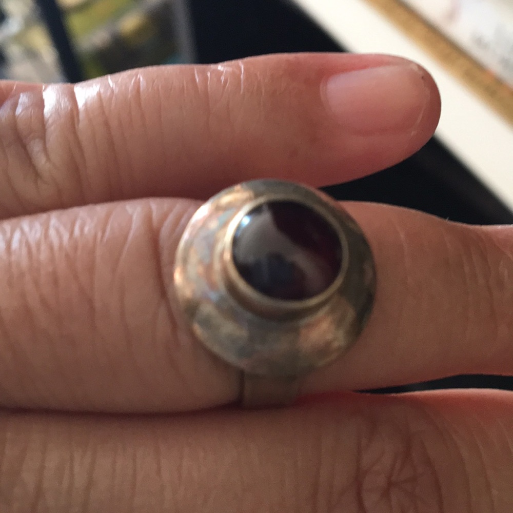Size 5 ring with a silver w/ patina & red stone.